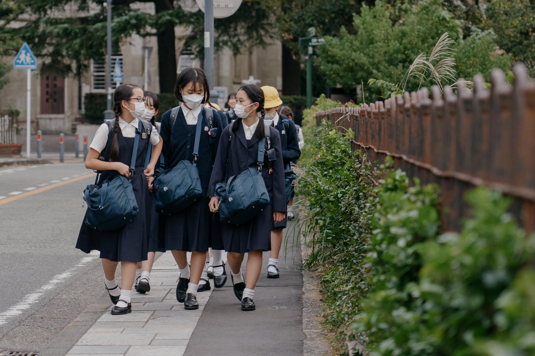 <span style="color: rgb(0, 0, 0);">Students in uniform in Yokohama. Most middle schools and high schools have strict policies regarding clothing and appearance. In recent years, some policies such as designated underwear color, hairstyles, and dyeing naturally brown hair black have come under question.</span>
