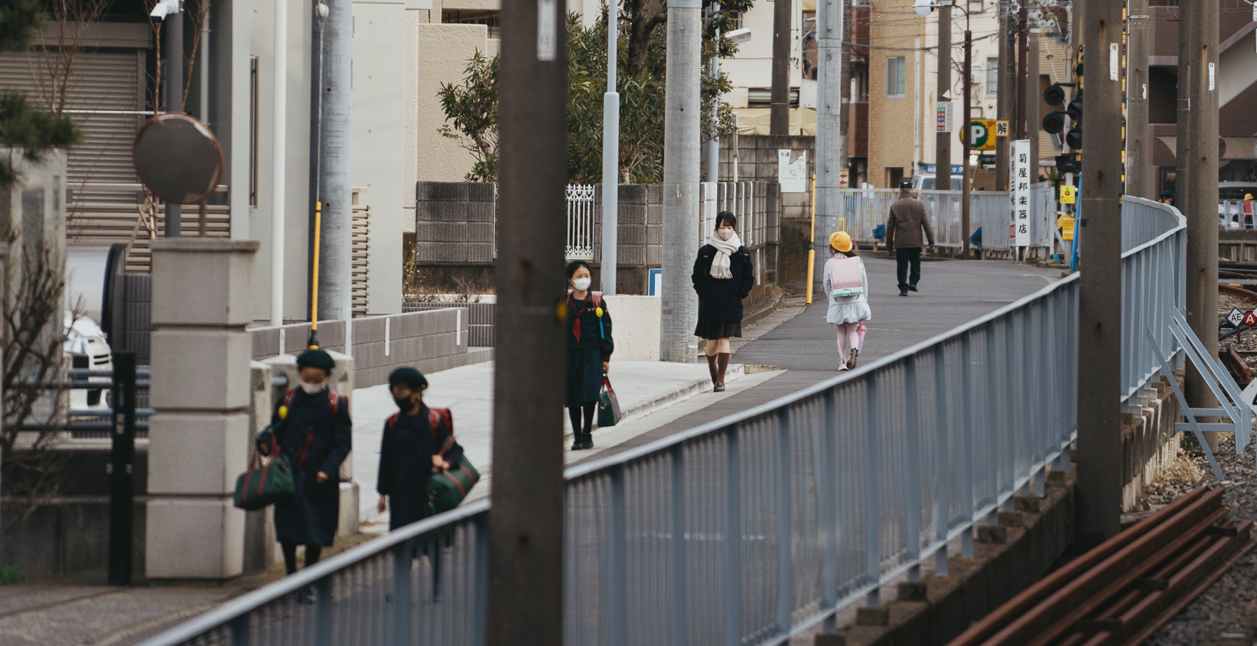 Students in uniform walking in a local neighborhood.