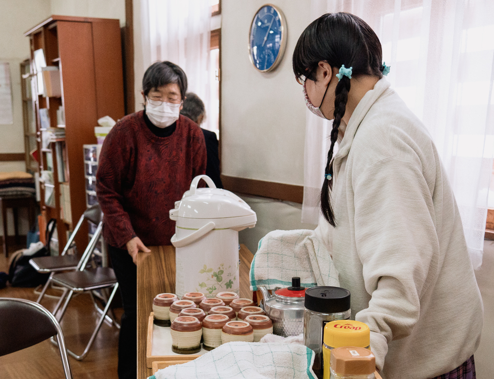 Two women setting up refreshments after church.