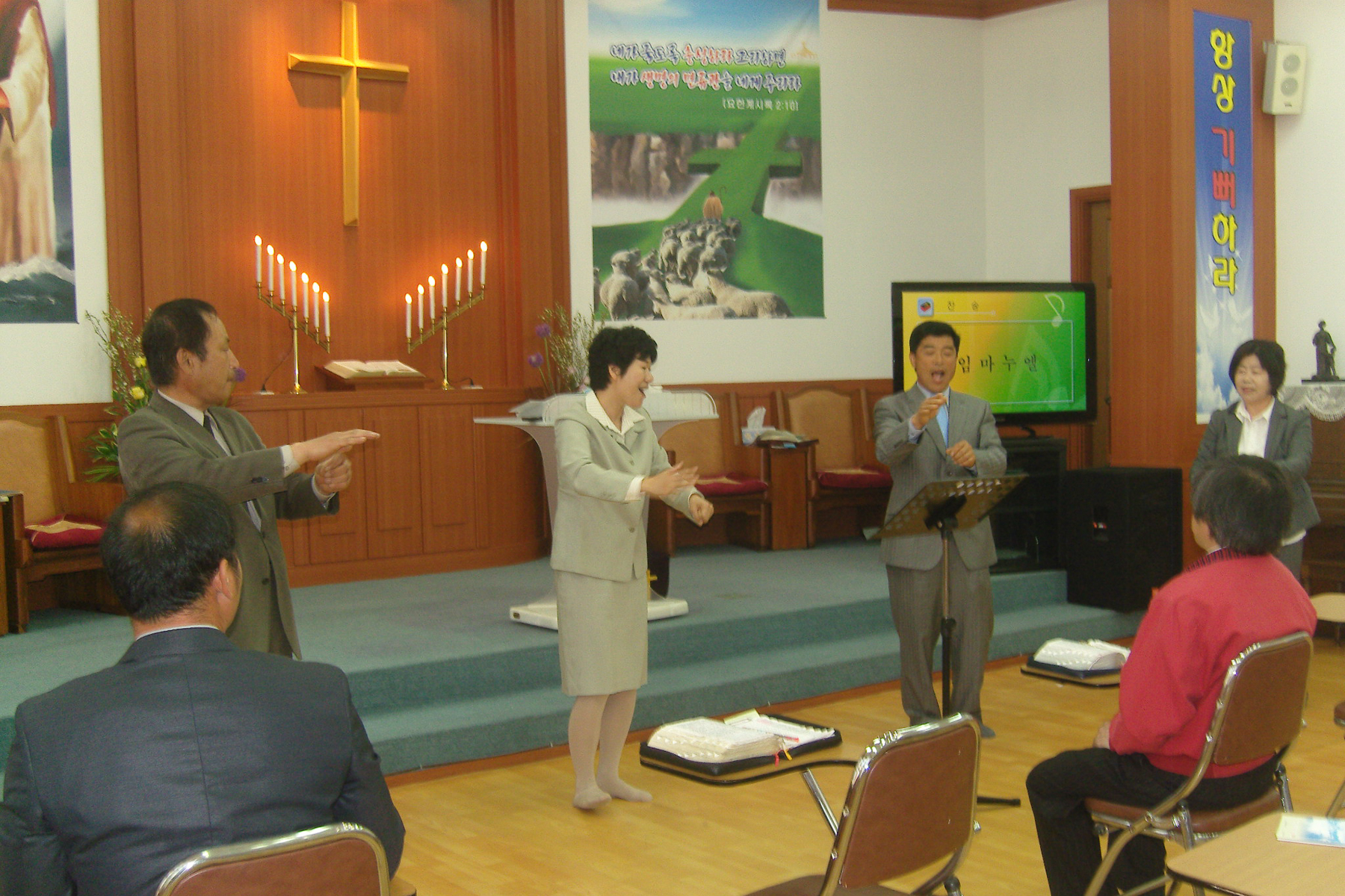 <span style="color: rgb(0, 0, 0);">Leading a worship service in sign language in South Korea.</span>